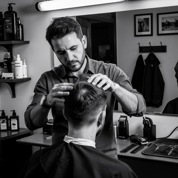 Barber assessing a client's hair during consultation