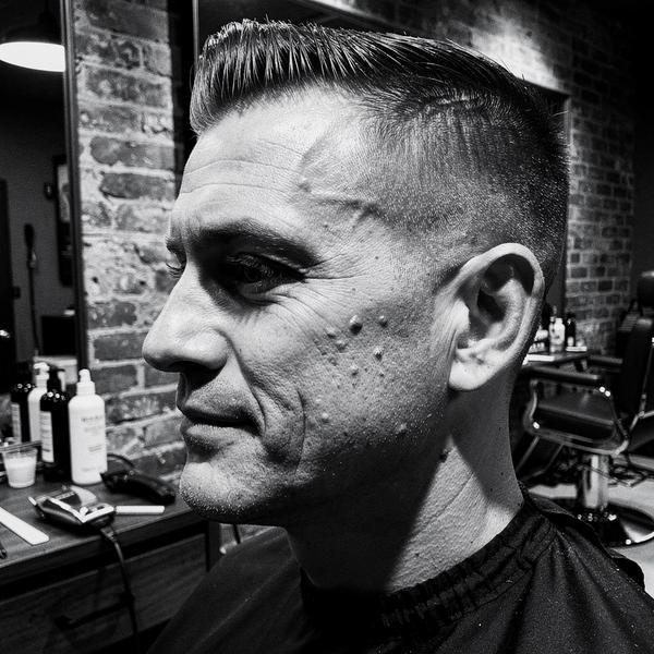 Client post-finish, styled hair checked from the side